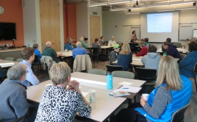 a room of people listen to instructions to start the Hub Simplification Workshop on Oct 1 2016