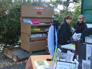 A visitor at the Alaska Junction Hub Grand Opening, with the new box in the background