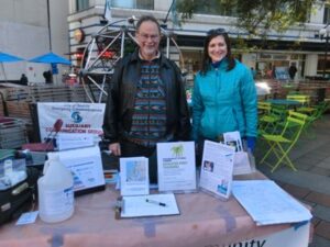 David Ward and Amy O'Donnell help at the Hub table in Westlake Park for the "Big Shaker" event, Oct 2016