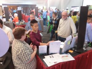 two people answer questions being asked by a Starbucks employee