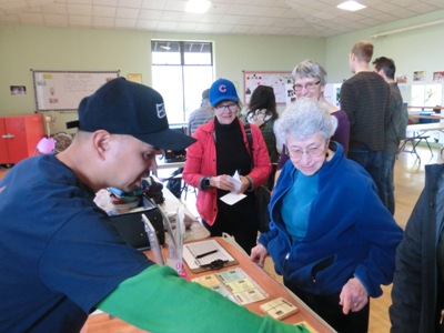 Orlando Castillo talks about hubs with visitors. He is the Hub Captain for the Beacon United Methodist Church, in south Beacon Hill