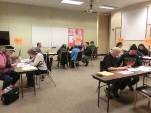 4 tables have volutneers seated at them to take messages from community role players