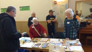 5 people standing at an informaiton table